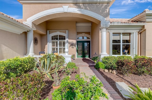 doorway to property with stucco siding and french doors