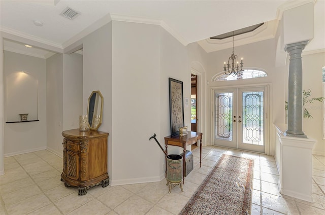 entrance foyer with decorative columns, visible vents, crown molding, and french doors