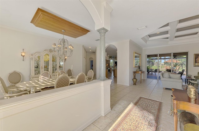 interior space with light tile patterned floors, decorative columns, coffered ceiling, ornamental molding, and a notable chandelier