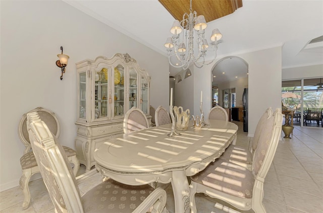 dining space featuring arched walkways, ornamental molding, light tile patterned floors, and a notable chandelier