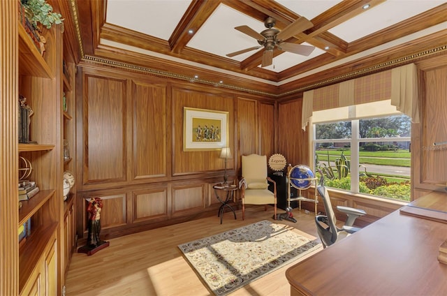 home office featuring light wood finished floors, ornamental molding, coffered ceiling, and beam ceiling