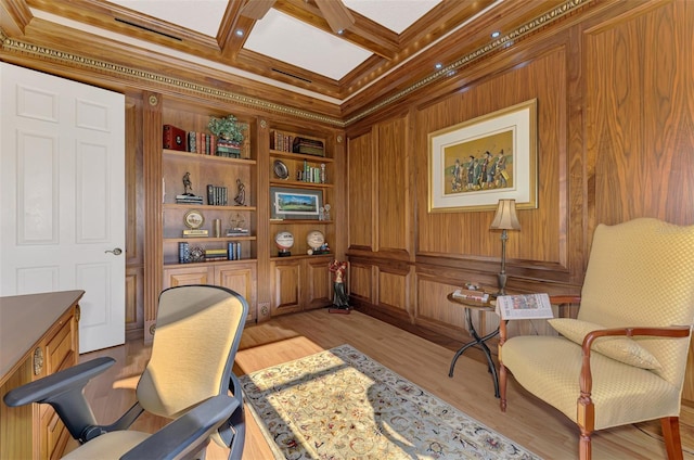 office space with ornamental molding, wood walls, light wood-type flooring, coffered ceiling, and beamed ceiling