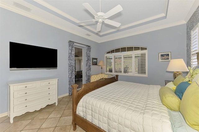 bedroom with visible vents, a tray ceiling, baseboards, and ornamental molding