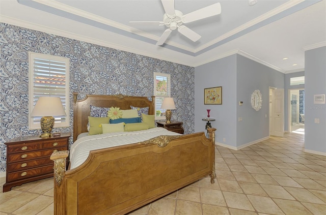 bedroom featuring baseboards, a tray ceiling, and wallpapered walls