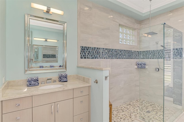 bathroom featuring a stall shower, ornamental molding, and vanity