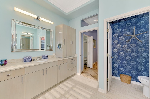 full bathroom featuring wood finish floors, vanity, and baseboards