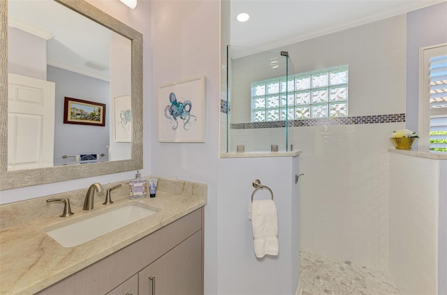 bathroom with a walk in shower, crown molding, and vanity