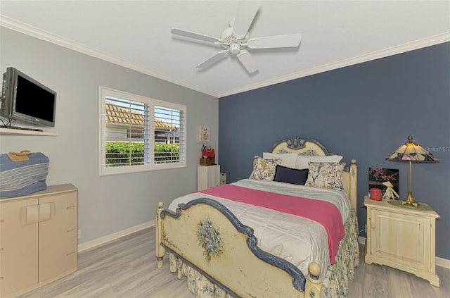 bedroom featuring baseboards, wood finished floors, a ceiling fan, and crown molding