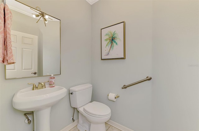 bathroom featuring toilet and baseboards