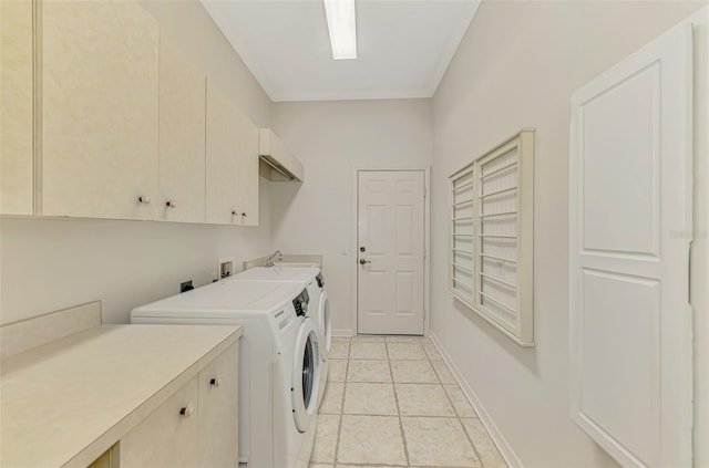 laundry room with light tile patterned floors, washing machine and dryer, baseboards, ornamental molding, and cabinet space