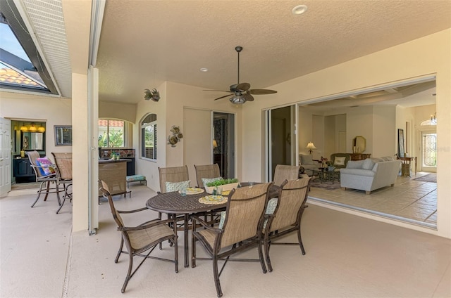 view of patio featuring a ceiling fan, outdoor dining area, and outdoor lounge area