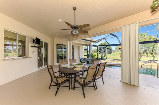 sunroom featuring a ceiling fan