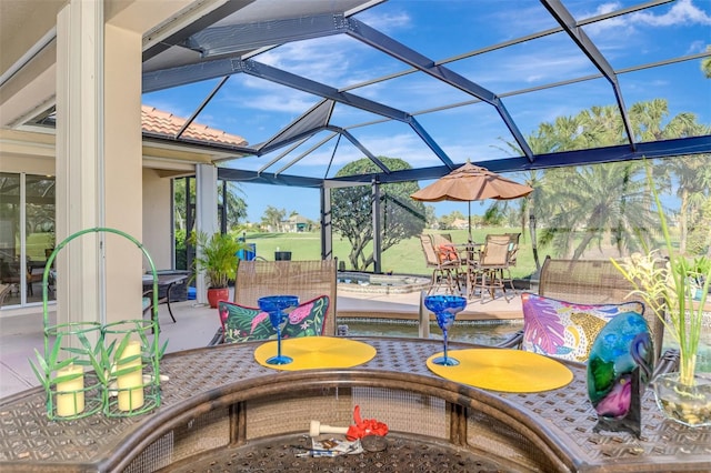 view of patio with a lanai, an outdoor fire pit, and outdoor dining area