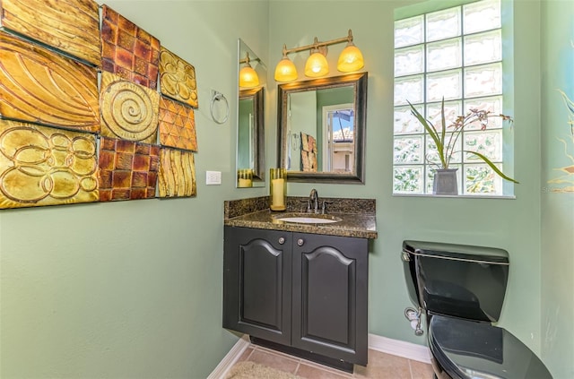 bathroom with tile patterned flooring, vanity, and baseboards