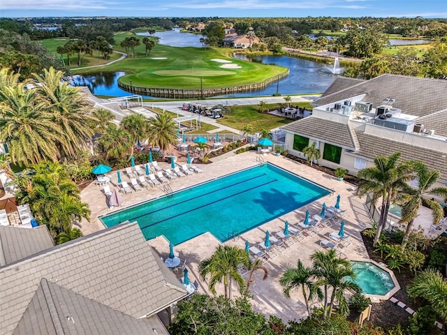 view of swimming pool with a water view, fence, golf course view, and a patio