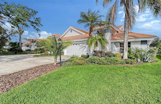 view of front of house with a garage and a front lawn