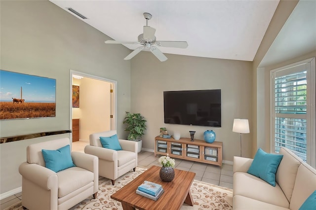 tiled living room featuring ceiling fan and lofted ceiling