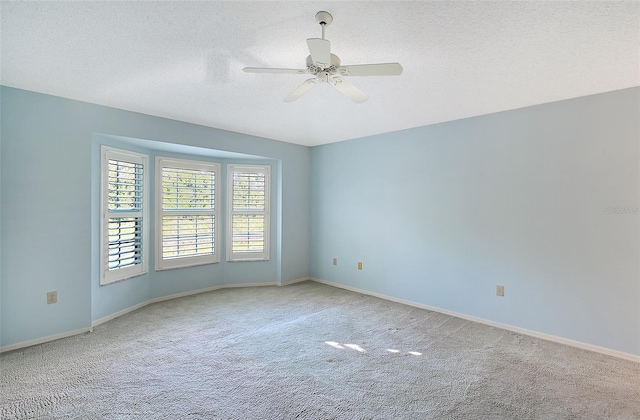 unfurnished room featuring carpet floors, ceiling fan, and a textured ceiling