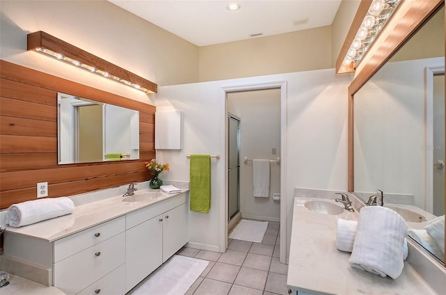 bathroom with an enclosed shower, vanity, and tile patterned flooring