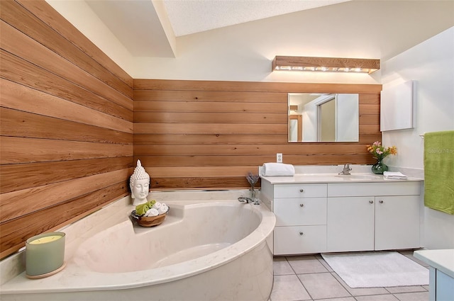 bathroom featuring a textured ceiling, tile patterned floors, vanity, wooden walls, and a tub to relax in