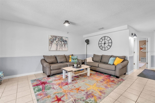 tiled living room featuring a textured ceiling