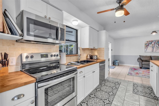 kitchen with stainless steel appliances and white cabinetry