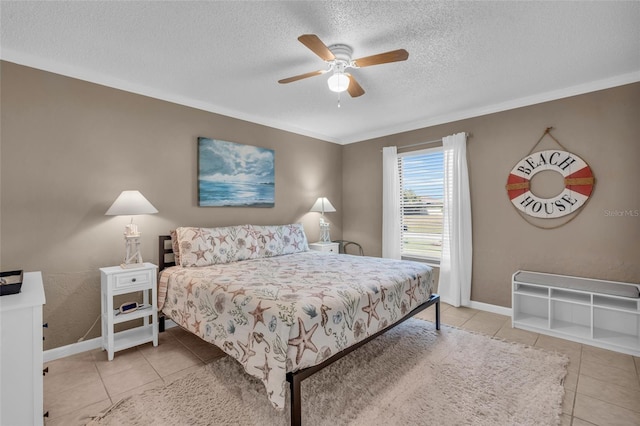 tiled bedroom featuring ceiling fan, a textured ceiling, and crown molding