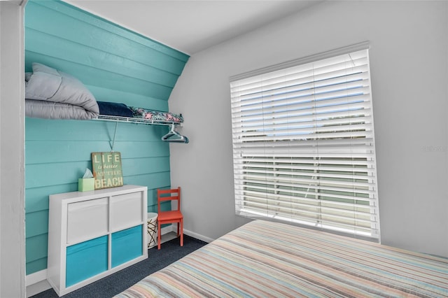 carpeted bedroom with vaulted ceiling