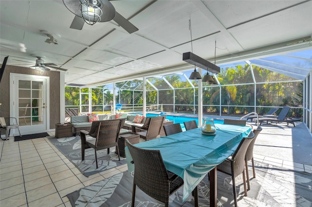 view of patio with ceiling fan, an outdoor hangout area, and glass enclosure