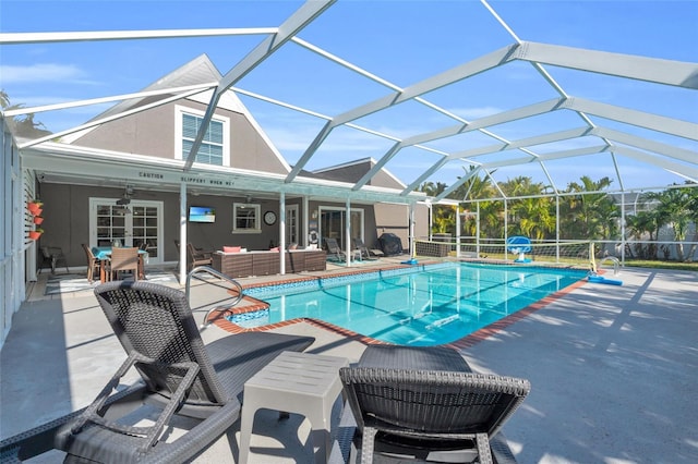 view of pool featuring a lanai, ceiling fan, a patio area, and outdoor lounge area