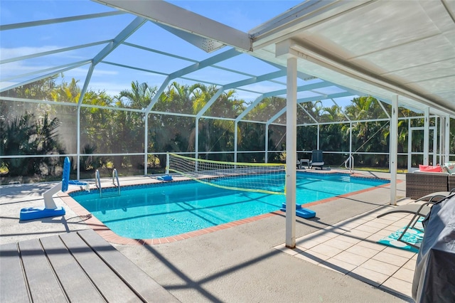 view of swimming pool with a lanai and a patio