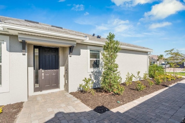 property entrance featuring stucco siding