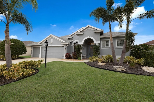 ranch-style house featuring a garage and a front lawn