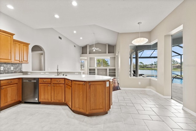 kitchen with hanging light fixtures, ceiling fan, dishwashing machine, sink, and backsplash