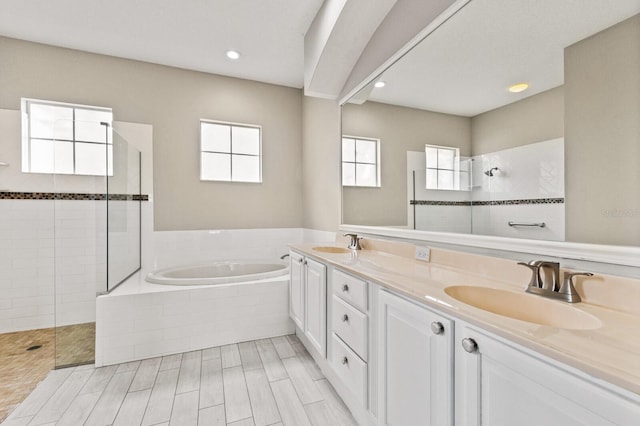 bathroom featuring vanity and separate shower and tub