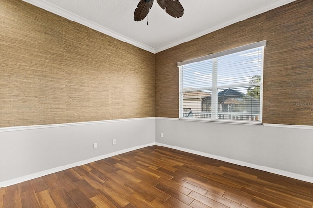 unfurnished room with ceiling fan, dark hardwood / wood-style flooring, and ornamental molding