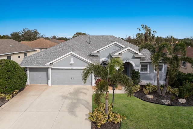 ranch-style home with a front yard and a garage