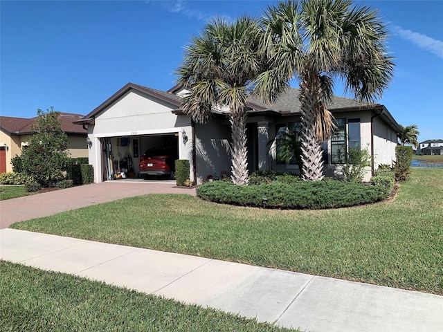 ranch-style house featuring a garage and a front yard