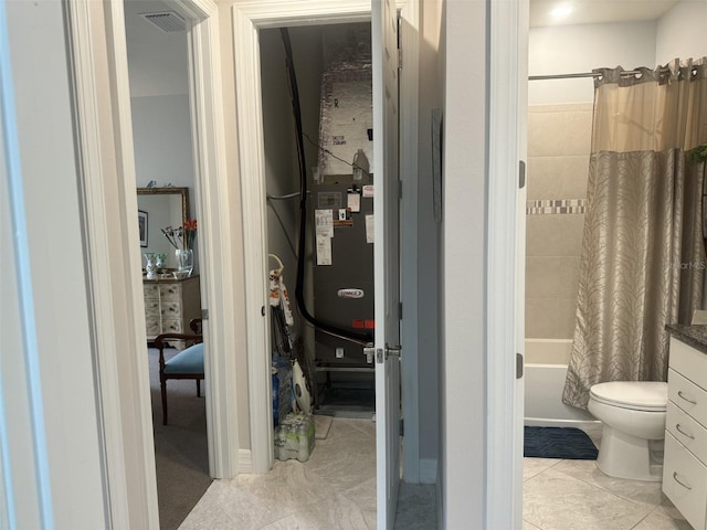 full bathroom featuring shower / tub combo with curtain, tile patterned floors, toilet, and vanity