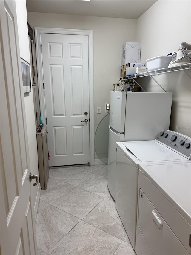 laundry area with washing machine and clothes dryer