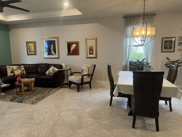 dining room with ornamental molding, ceiling fan, and a tray ceiling