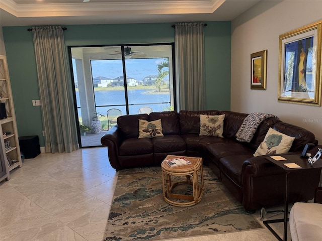 living room with ornamental molding, a raised ceiling, and a water view