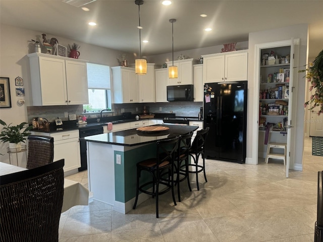 kitchen with sink, a center island, black appliances, white cabinets, and decorative light fixtures