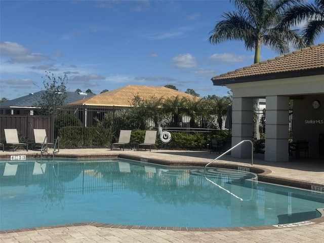 view of swimming pool featuring a mountain view and a patio