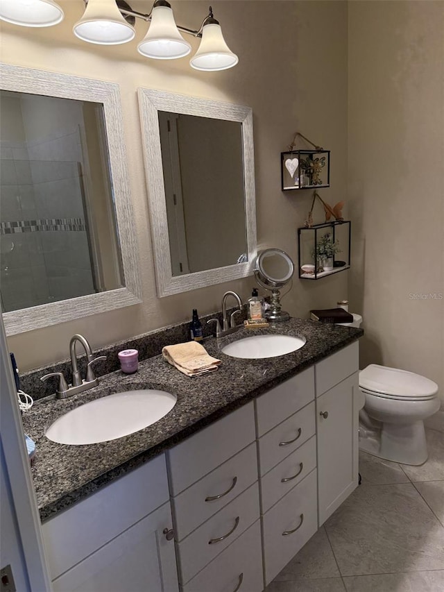 bathroom featuring vanity, toilet, and tile patterned flooring