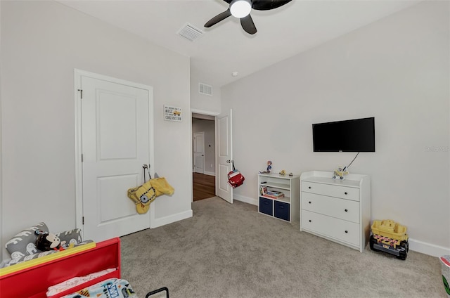 playroom featuring light carpet and ceiling fan