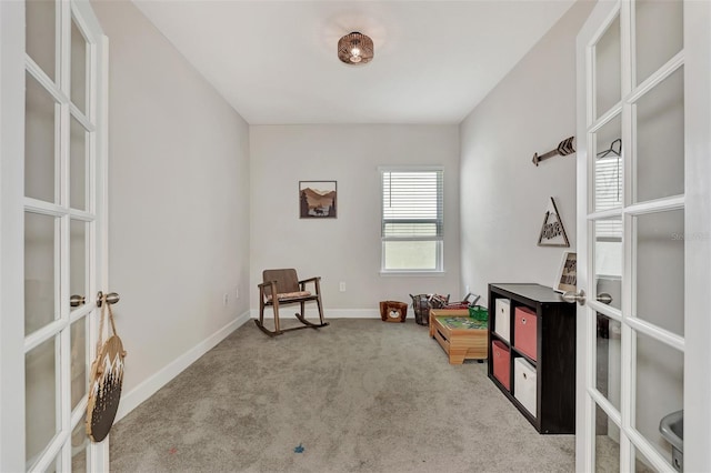 rec room featuring light colored carpet and french doors