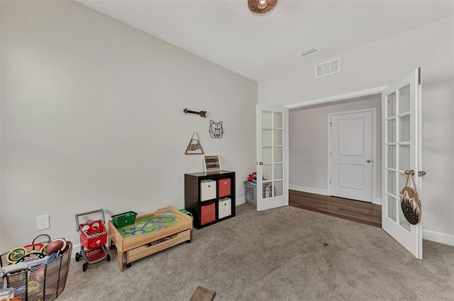 recreation room featuring light colored carpet and french doors