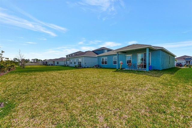 rear view of house with a yard