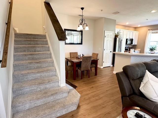 interior space featuring light hardwood / wood-style floors and a chandelier